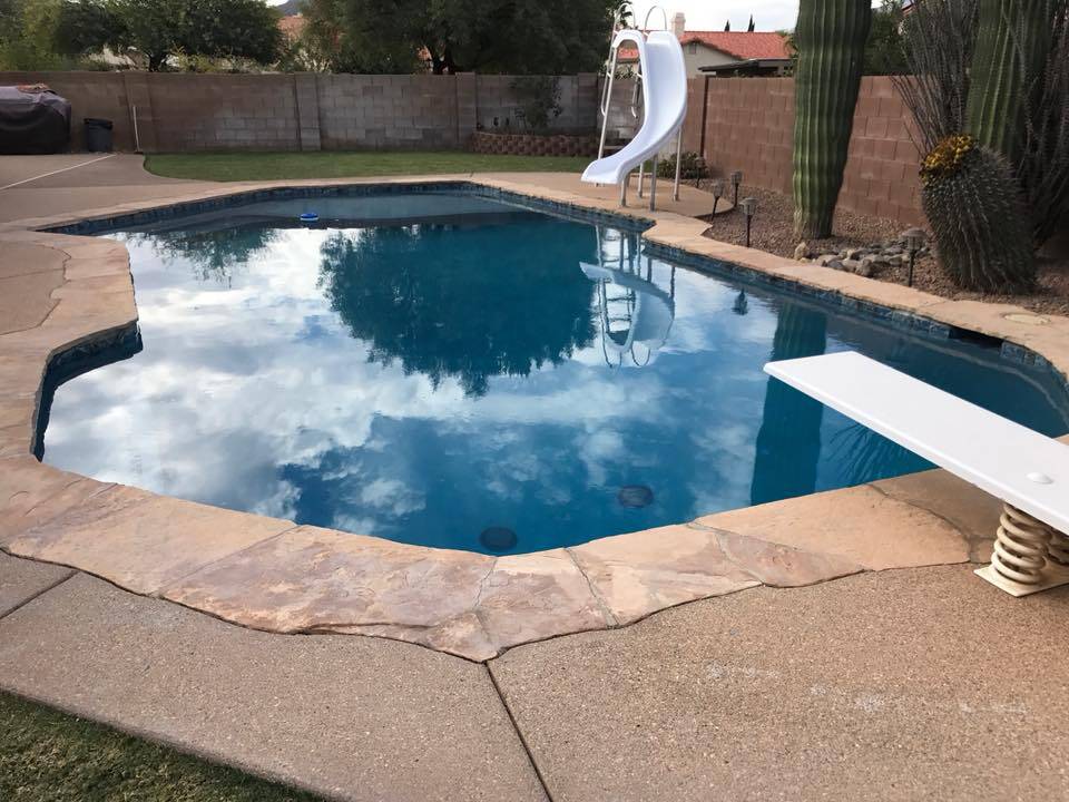 pool with diving board and slide