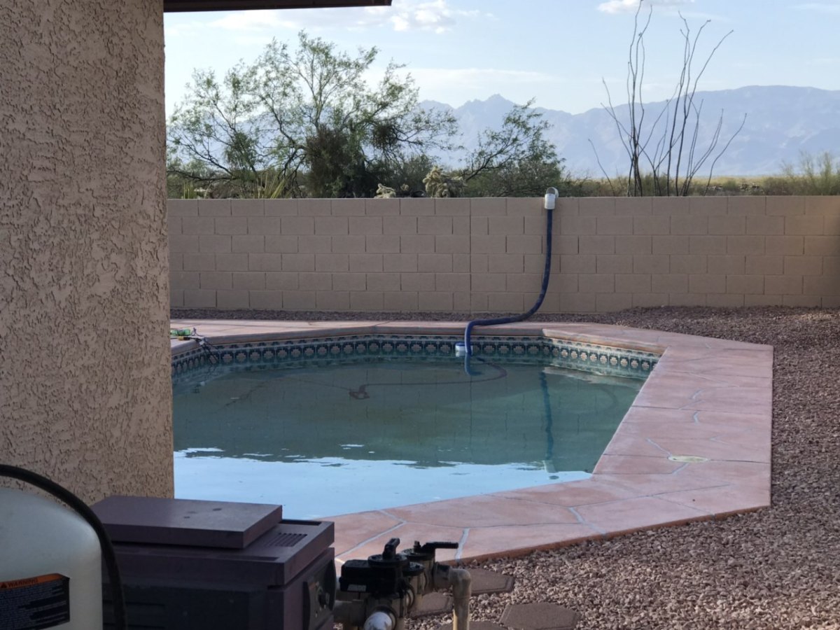 Pump draining a pool before demolition