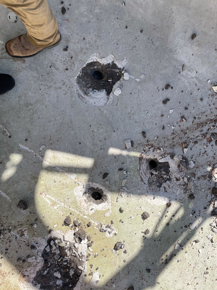 Several drainage holes across a pool floor
